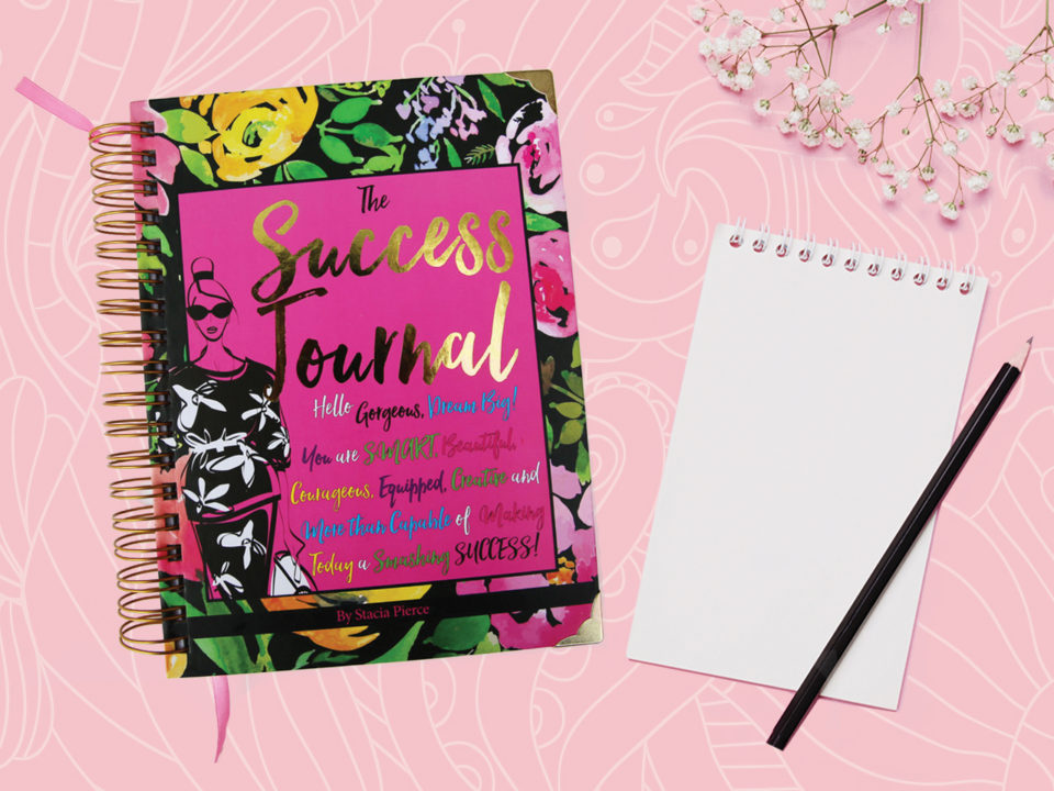 Journal, notebook and pencil on pink background