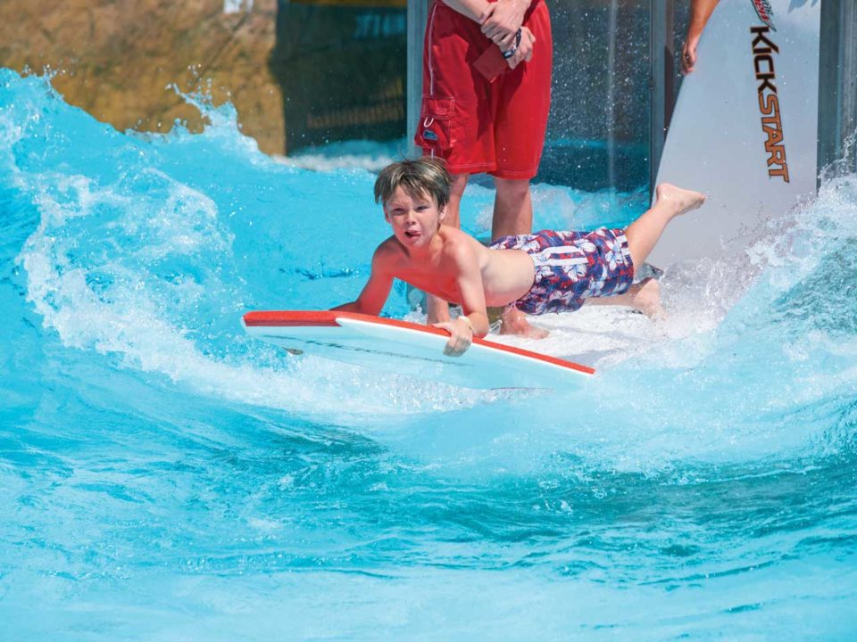 Boy surfing in pool