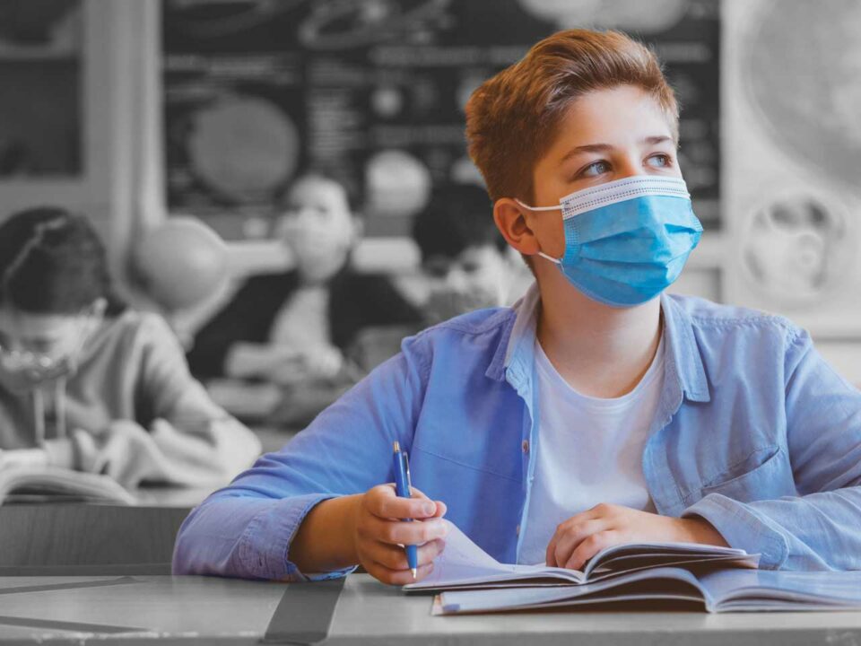 Boy at school wearing mask