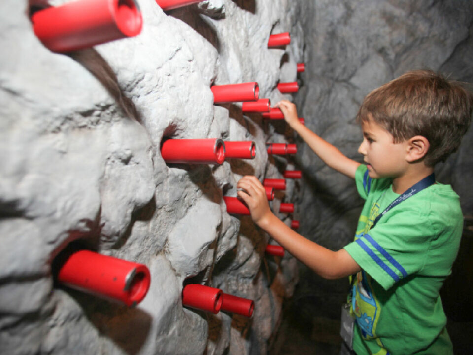 Child playing with sensory wall