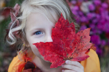 Little girl with red leaf